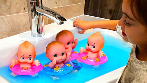 baby dolls swimming in the sink